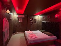 Couple treatment room with warm red lighting at Rejoice International Spa